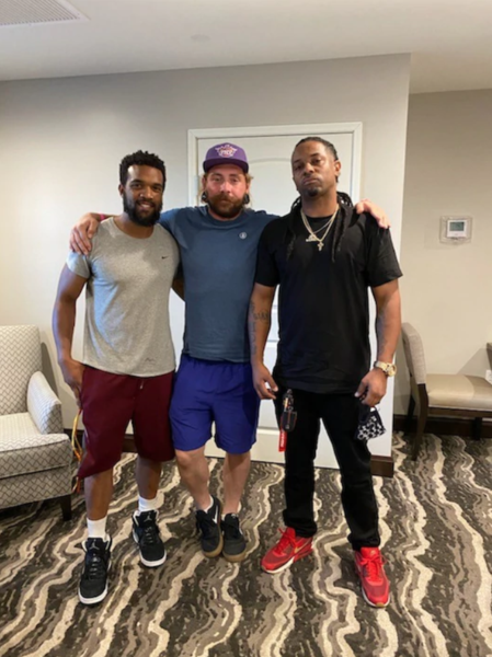 Phillip Blanks, 28, left, and D’Artagnan Alexander, 42, right, meet Corey Long, the father of the children they rescued from a fire on Friday. (Maranda Carruth)